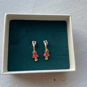 Gold hoop earrings with red mushroom pendants